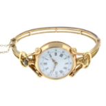 An early 20th century 15ct gold hinged bangle, with mounted 18ct gold fob watch.