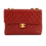 CHANEL - a red lambskin leather Jumbo flap handbag.