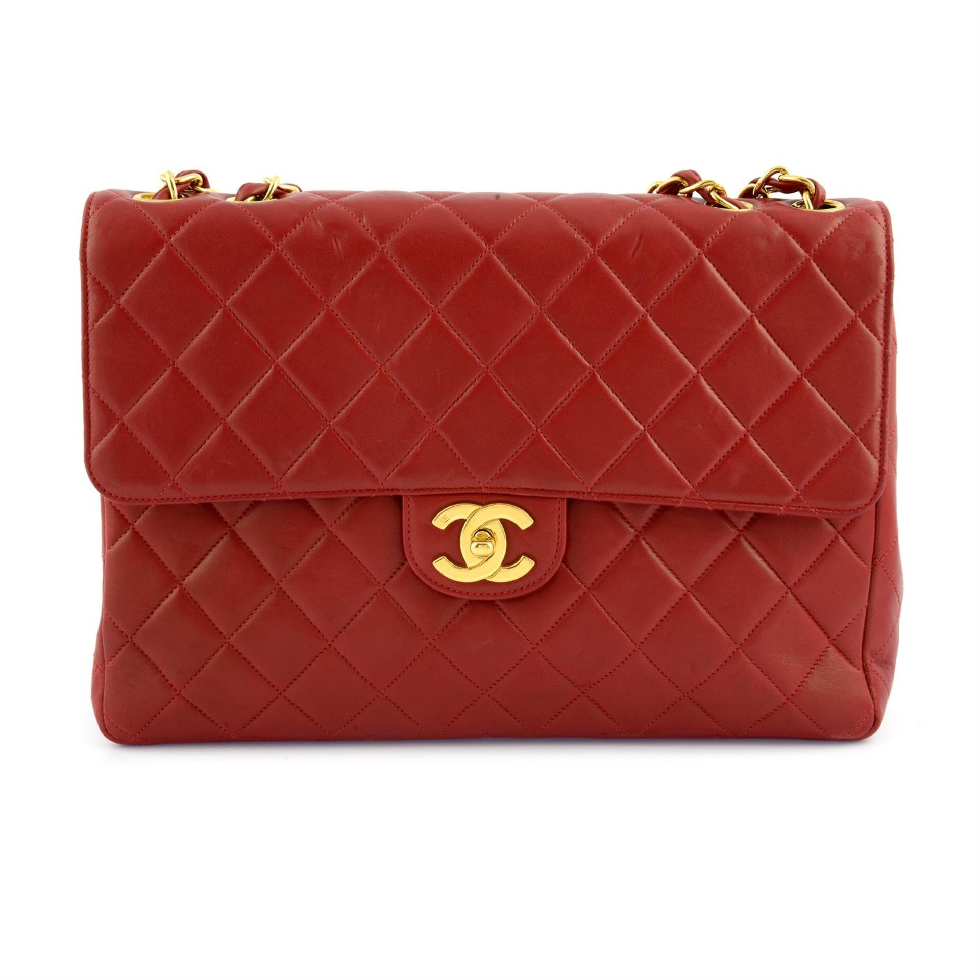 CHANEL - a red lambskin leather Jumbo flap handbag.