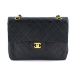 CHANEL - a navy lambskin leather classic double flap handbag.