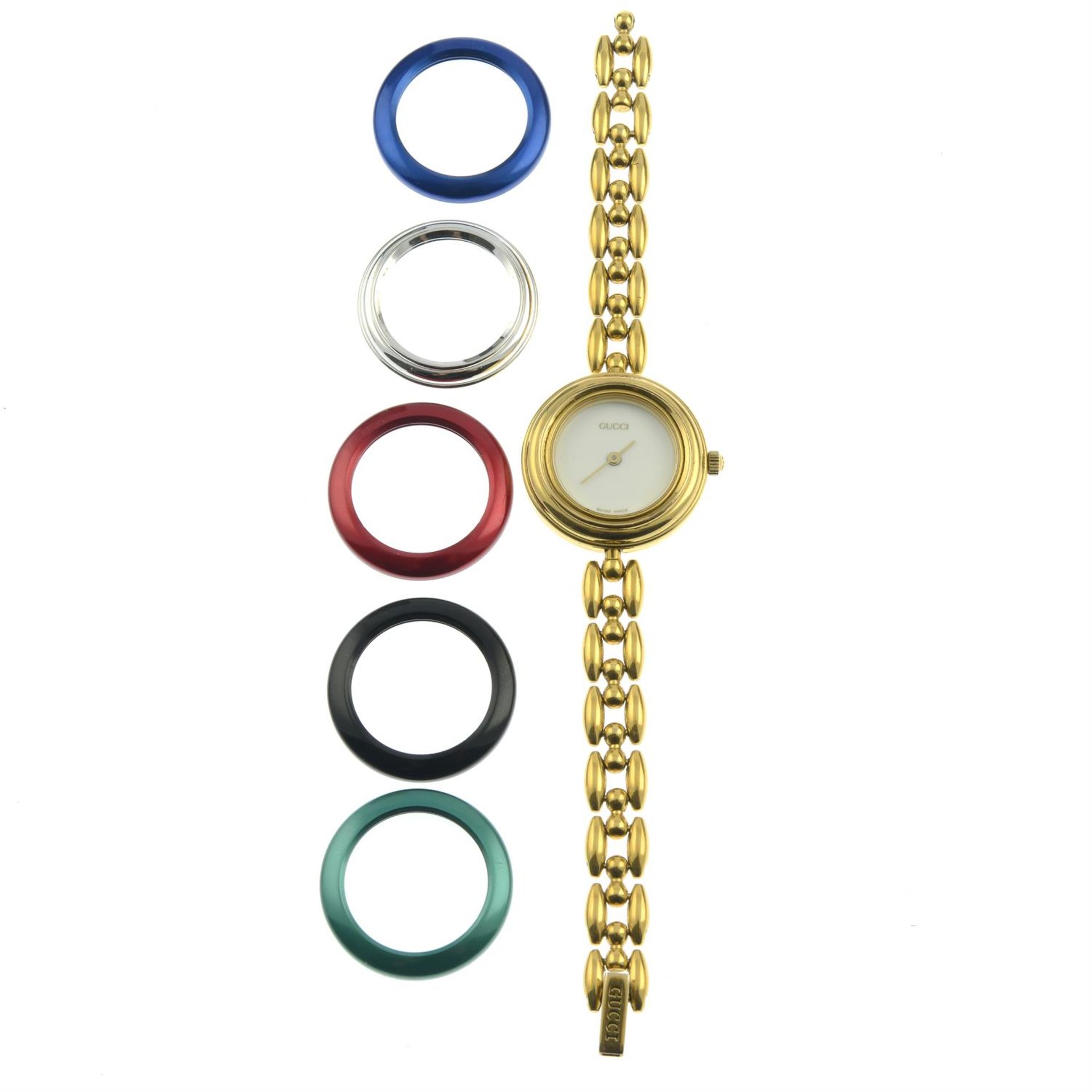 GUCCI - a watch with interchangeable variously coloured bezels.