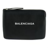 BALENCIAGA - a black leather clutch bag.