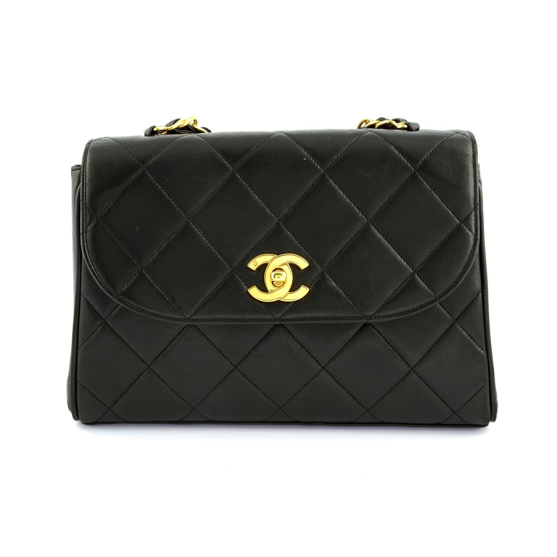 CHANEL - a black lambskin leather top handle single flap handbag.