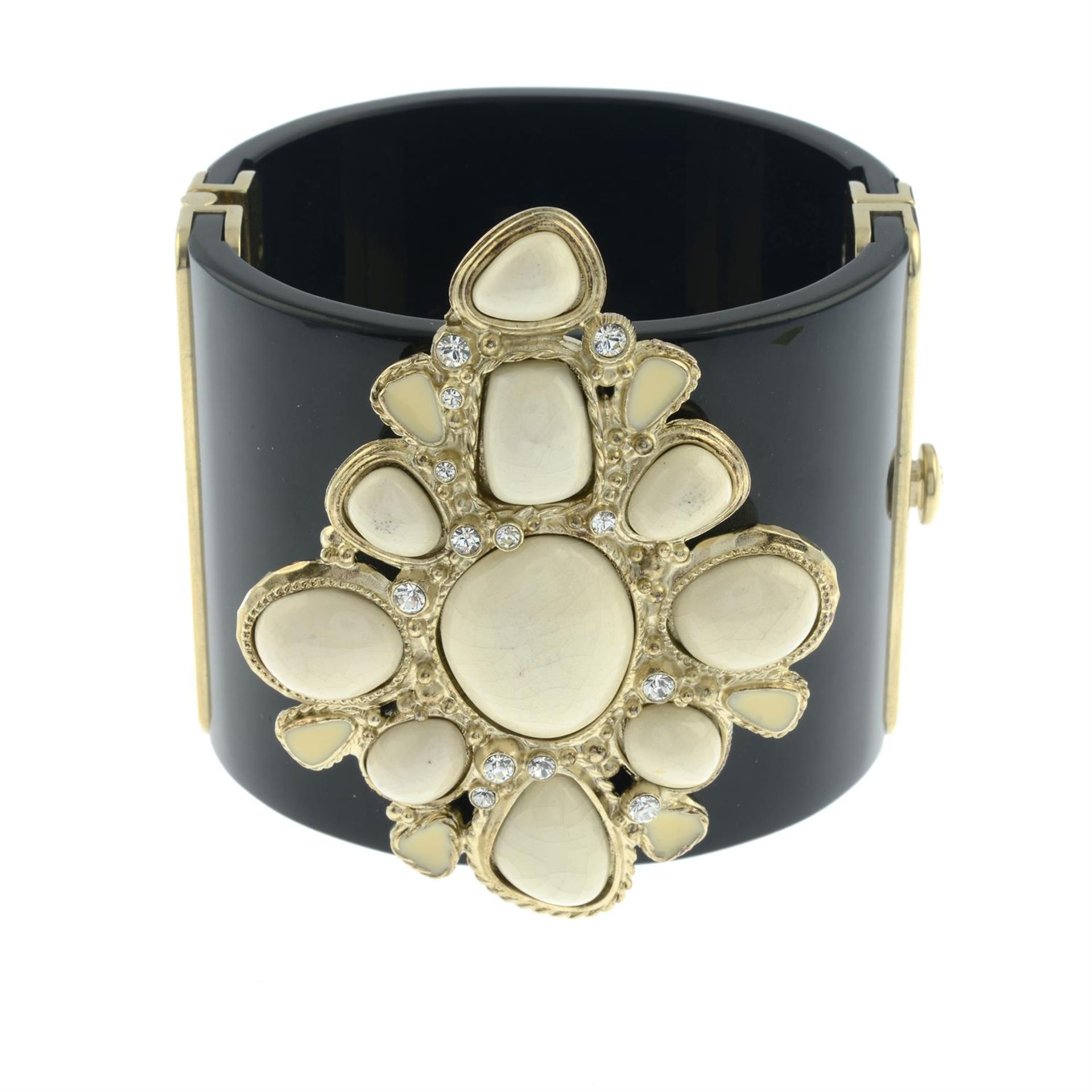 CHANEL - a hinged black cuff with cream enamel and glazed panel.
