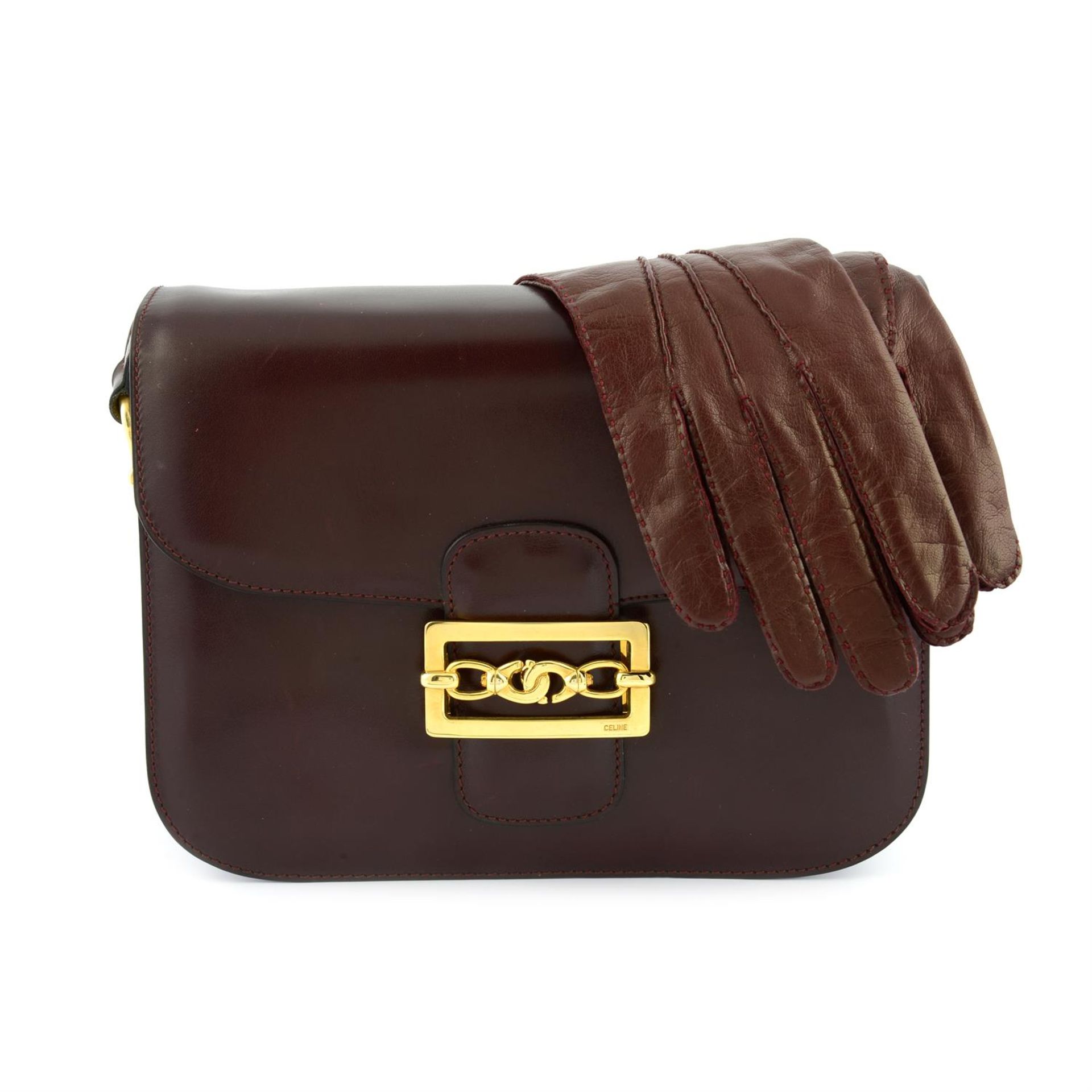 CÉLINE - a burgundy leather shoulder bag and matching leather gloves.