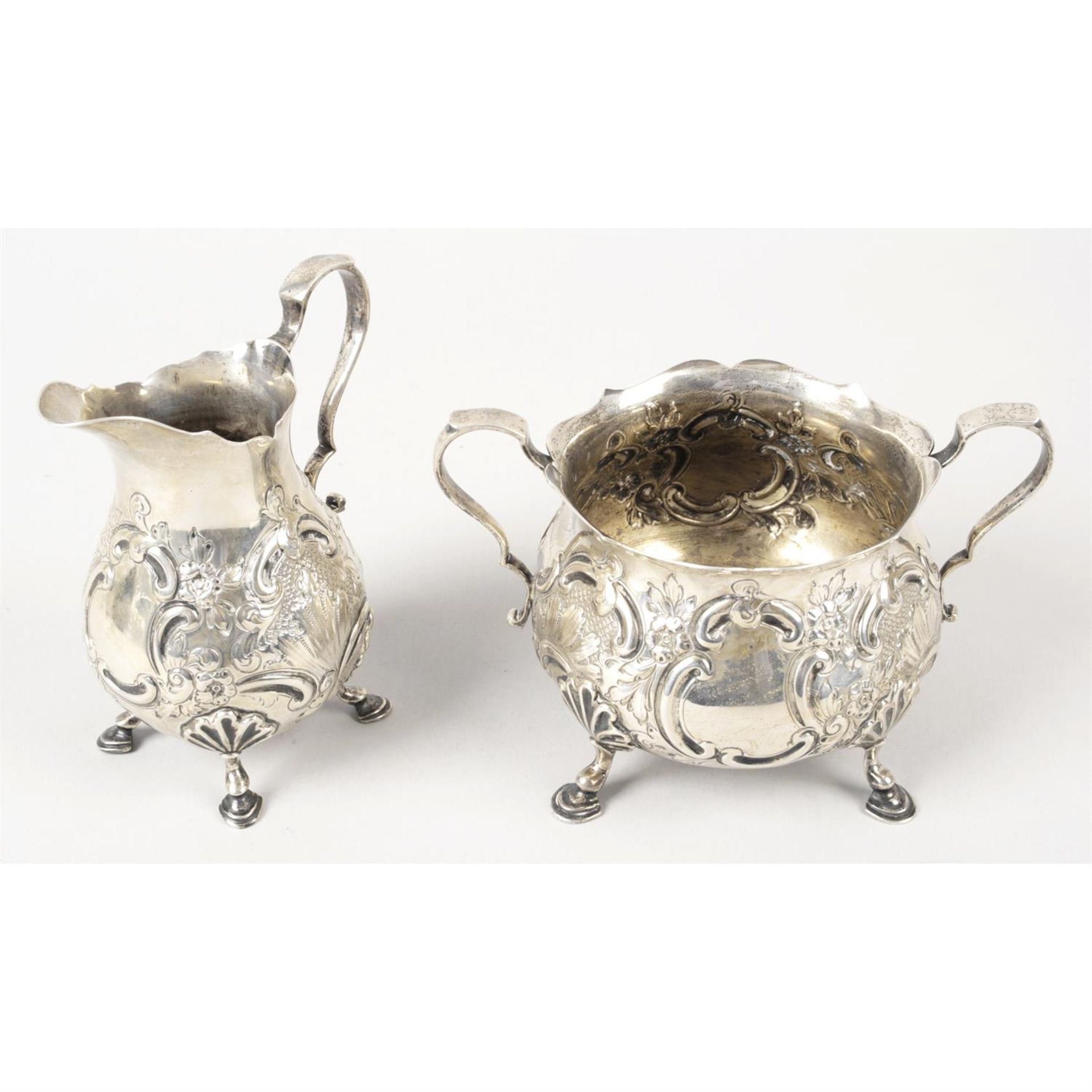 A late Victorian silver cream jug & matching sugar bowl. (2).