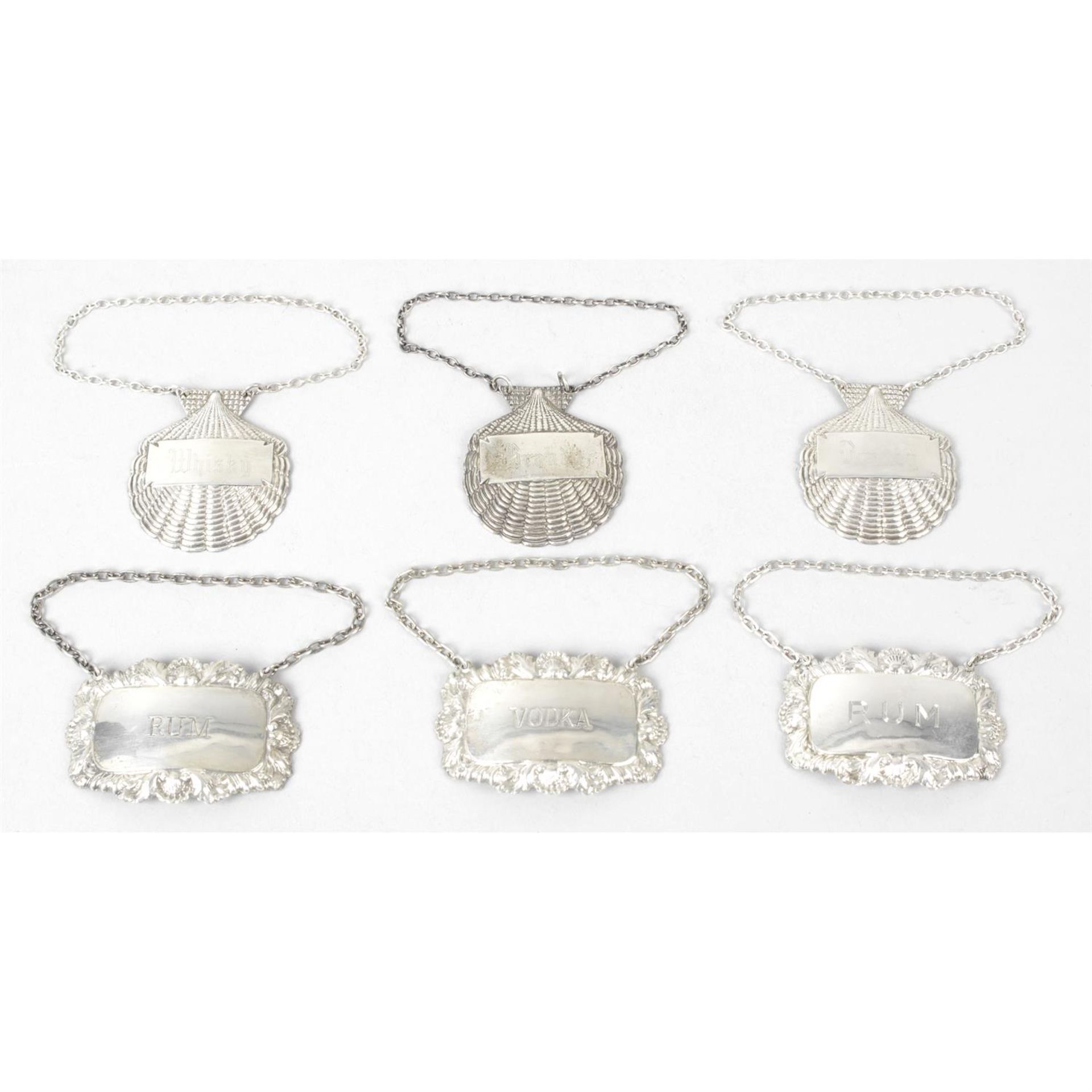 A set of three modern silver scallop shell wine labels; together with three further modern examples.