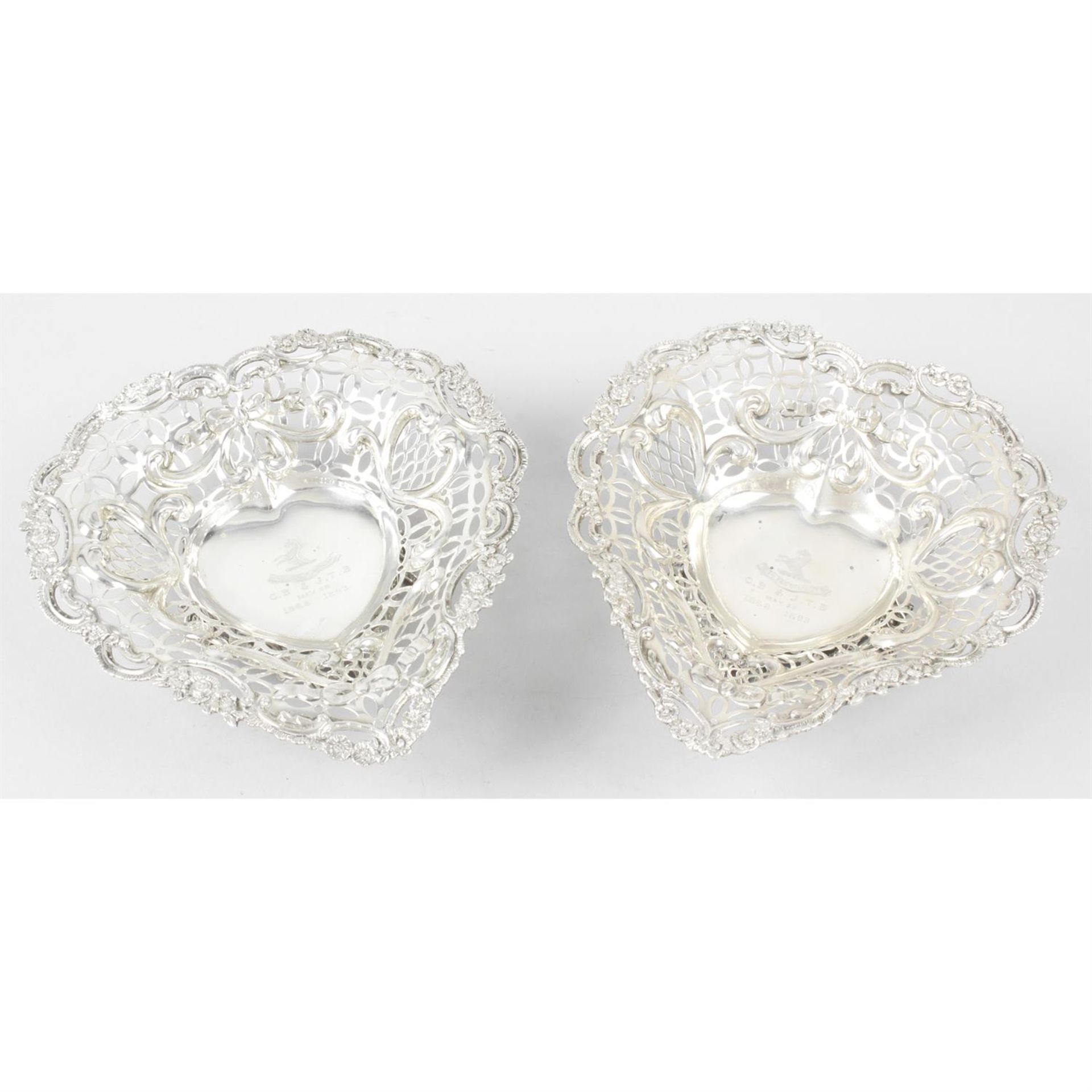 A pair of late Victorian silver heart shaped pierced dishes.