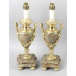 A pair of green marble and gilt metal twin handled lamp holders.