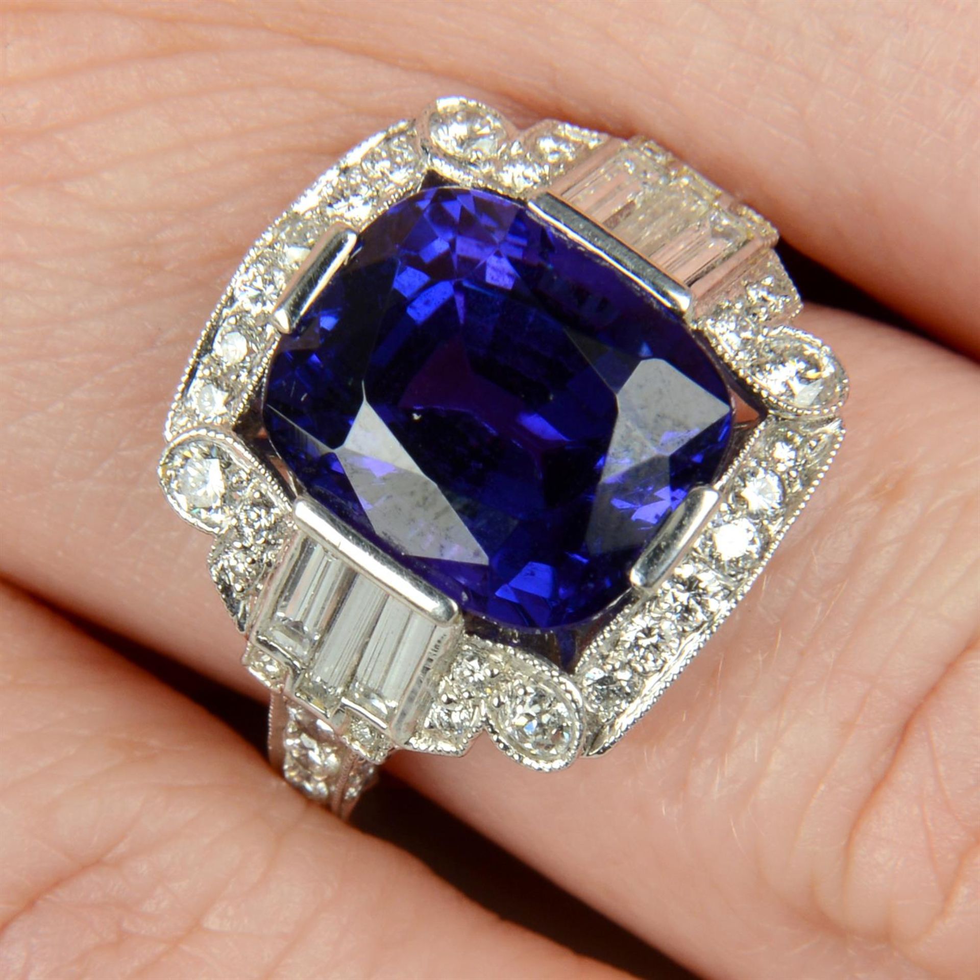 A tanzanite dress ring, with baguette and brilliant-cut diamond surround.