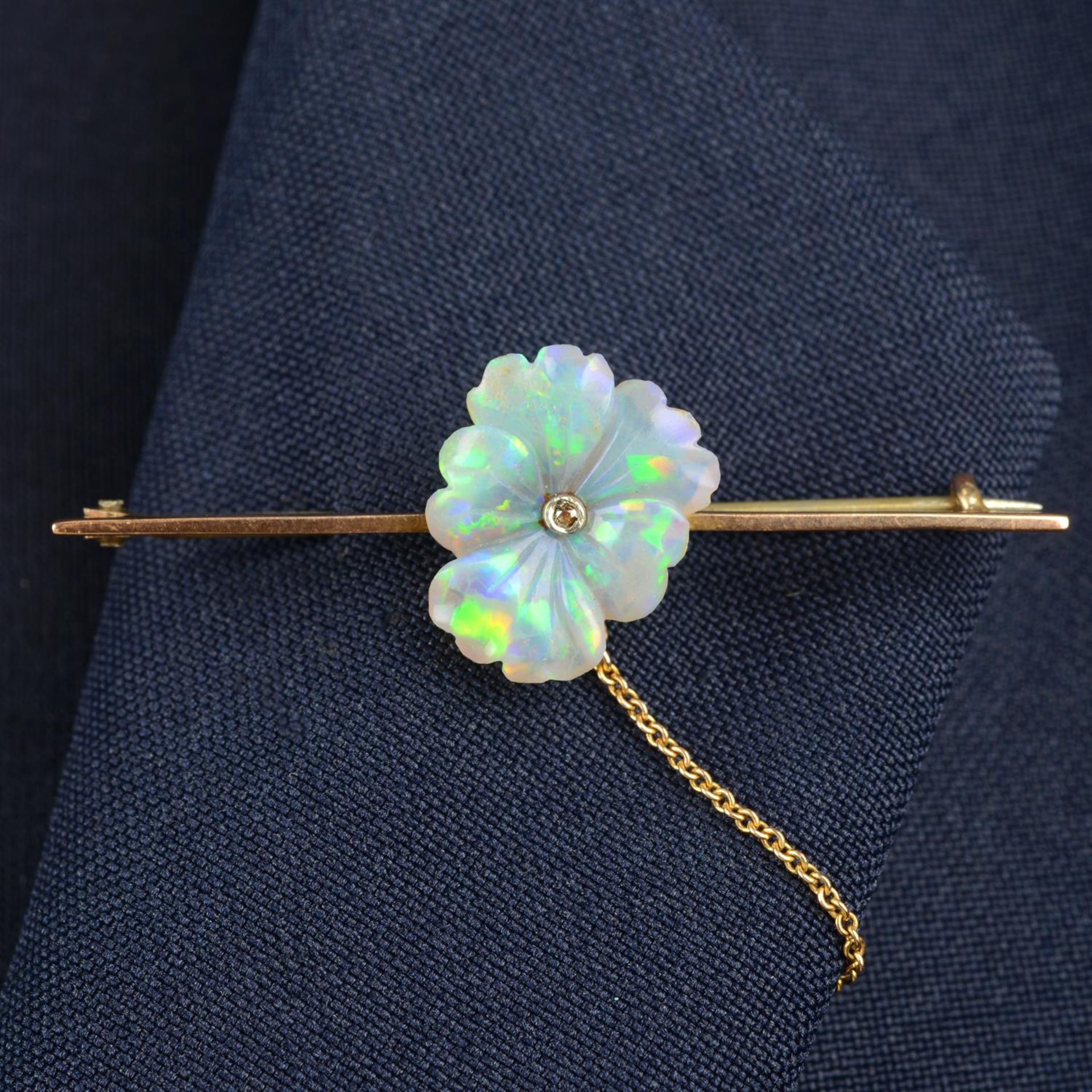 An early 20th century 9ct gold, diamond and carved opal pansy flower brooch.