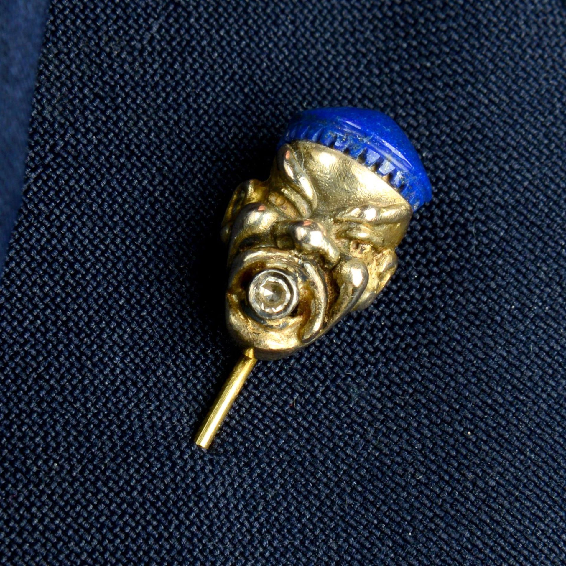 An early 20th century gold stickpin, depicting the bust of a man, with lapis lazuli hat,