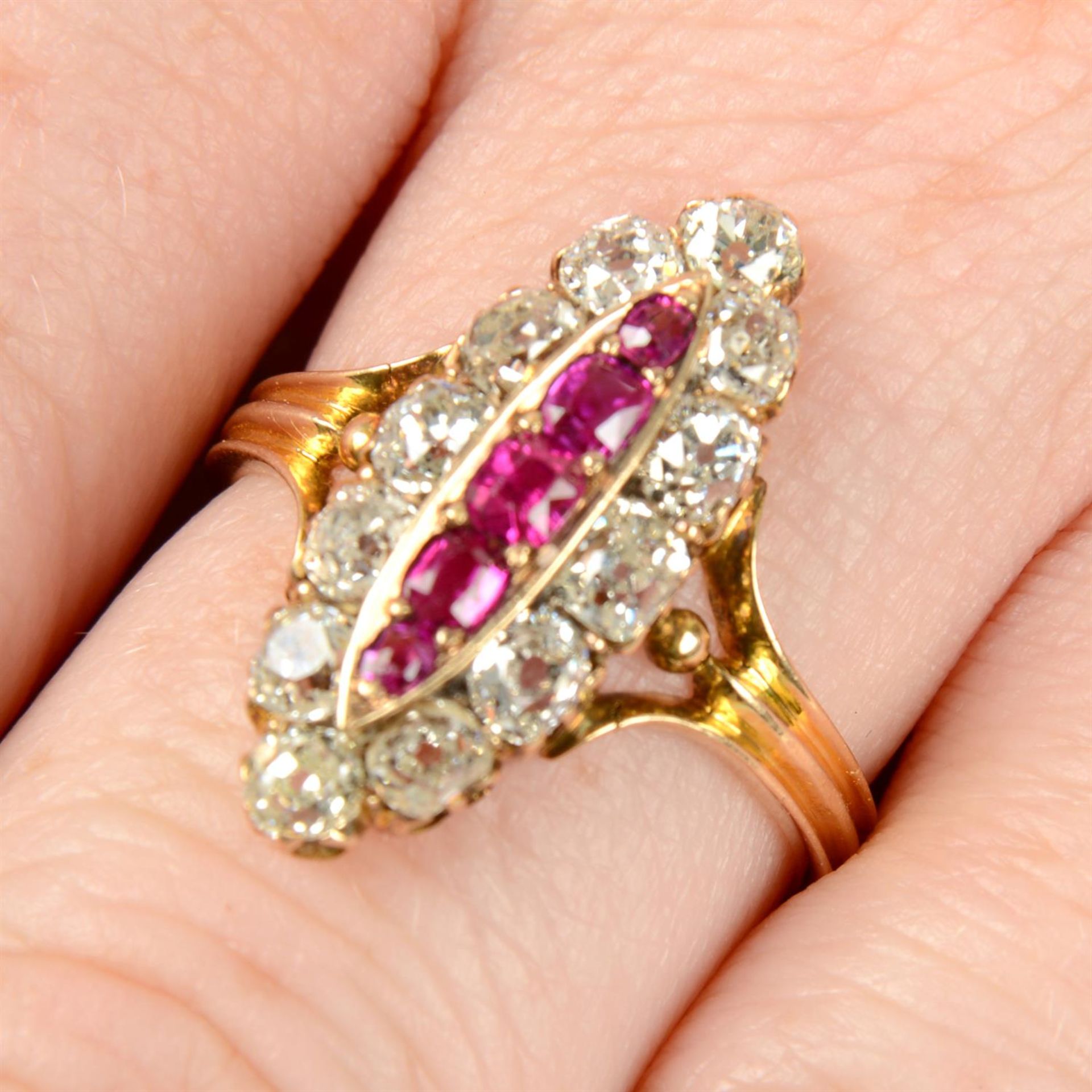 A late 19th century gold ruby and old-cut diamond marquise-shape cluster ring.