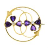 An early 20th century 18ct gold amethyst and seed pearl floral brooch.