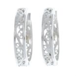 A pair of openwork hoop earrings.