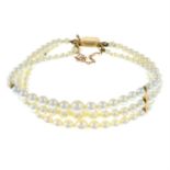 A cultured pearl three-row bracelet.