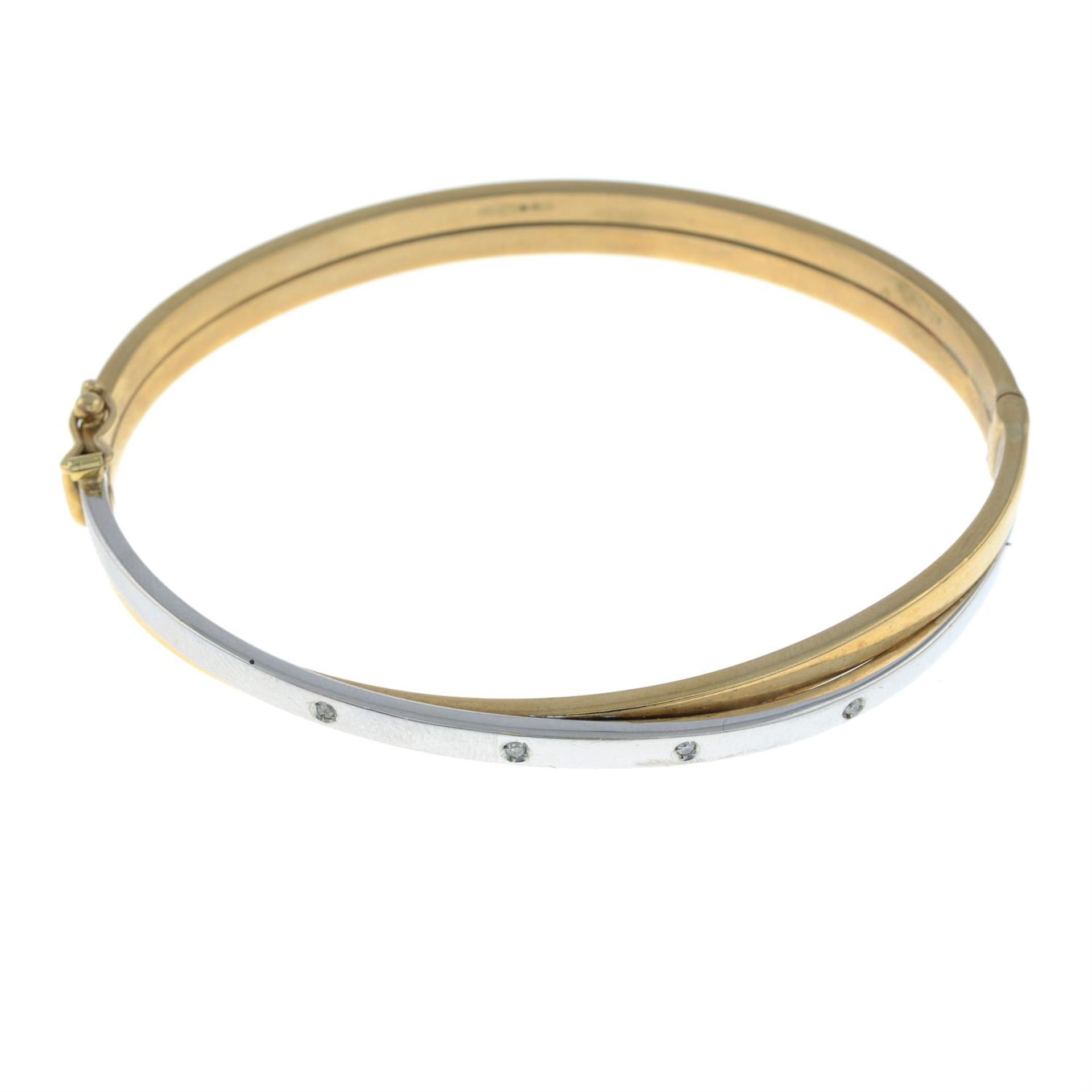 A 9ct gold bi-colour bangle, with diamond accents.