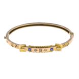 An early 20th century 9ct gold sapphire and diamond accent buckle bangle.