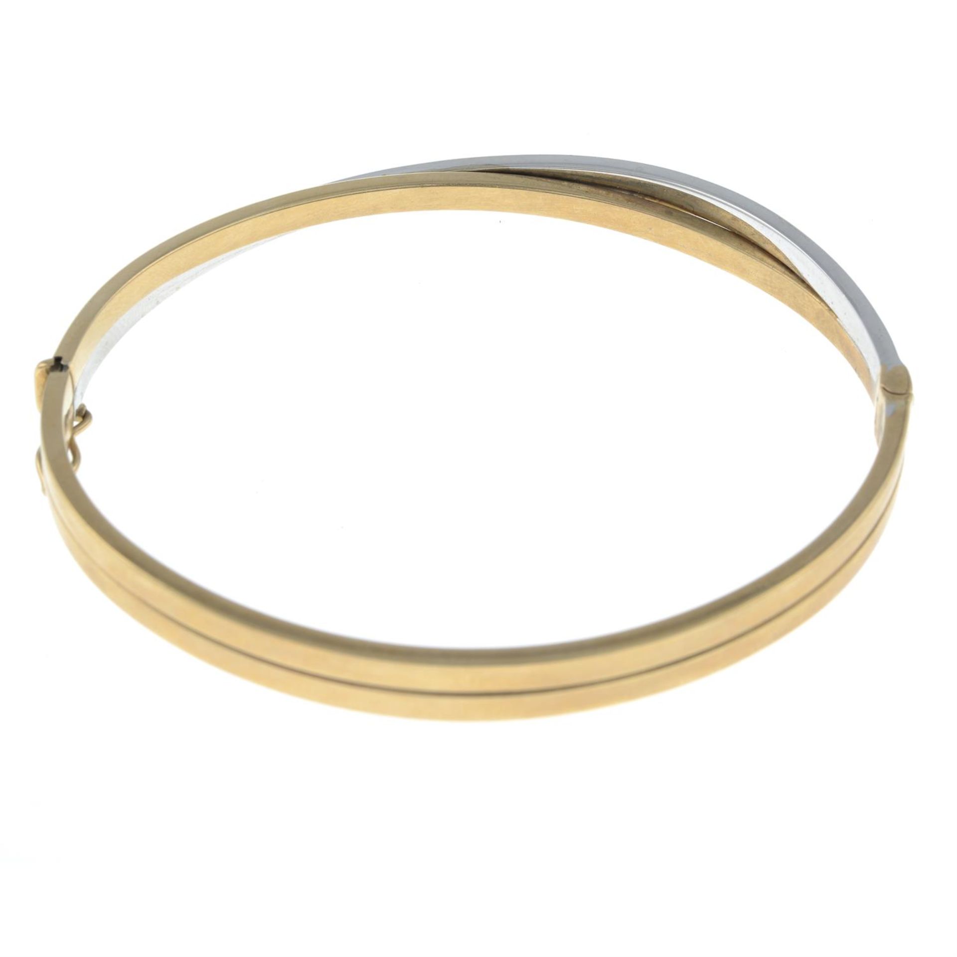 A 9ct gold bi-colour bangle, with diamond accents. - Image 2 of 2