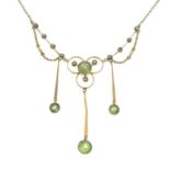 An early 20th century 9ct gold peridot and split pearl drop pendant, on an integral chain.