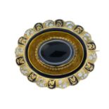 A mid Victorian banded agate and enamel mourning brooch.