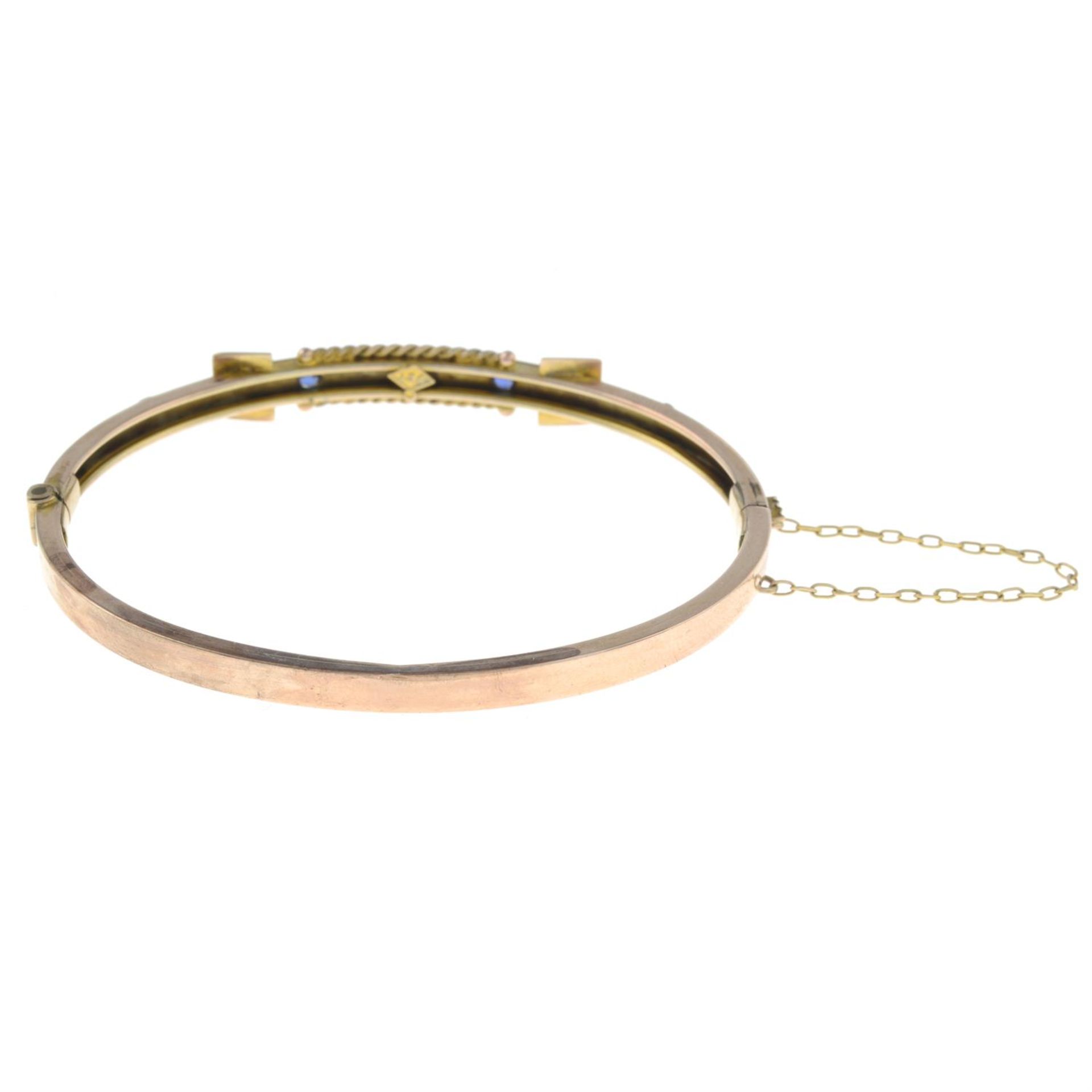 An early 20th century 9ct gold sapphire and diamond accent buckle bangle. - Image 2 of 2