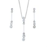 A set of diamond jewellery, comprising a pair of earrings and a pendant with chain.