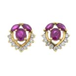 A pair of brilliant-cut diamond and ruby stud earrings.