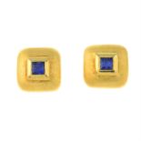 A pair of sapphire accent stud earrings.