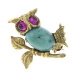 A turquoise and ruby owl brooch.