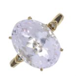 A kunzite single-stone ring, with diamond accent shoulders.