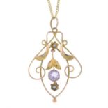 An early 20th century 9ct gold amethyst and split pearl openwork pendant, with 9ct gold chain.