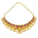 An 18ct gold synthetic pink sapphire necklace.
