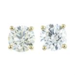 A pair of brilliant-cut diamond stud earrings.