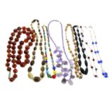 Eight gem-set single-strand necklaces.