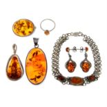 Six items of amber and resin jewellery, comprising a ring, a pair of drop earrings, a brooch,