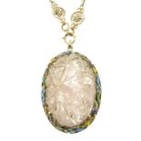 A carved rose quartz floral pendant, with enamel surround, suspended from a fancy-link chain.