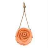 A carved coral floral pendant.