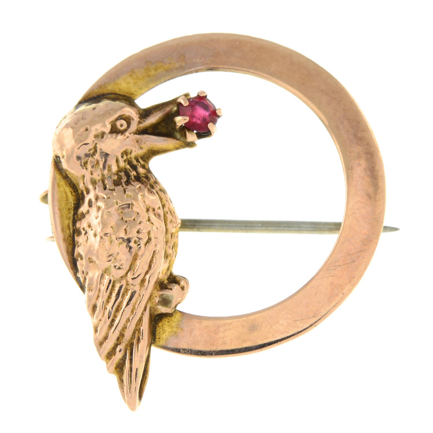 An early 20th century 9ct gold woodpecker brooch, with red paste highlight.
