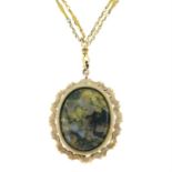 A fancy-link chain, suspending a moss agate pendant.