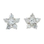 A pair of 18ct gold brilliant-cut diamond star cluster earrings.
