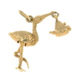 A 1960s 9ct gold charm, designed as a textured stork, delivering a new born baby.
