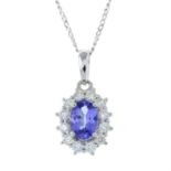 An 18ct gold tanzanite and diamond cluster pendant, with trace-link chain.