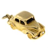 A 9ct gold vintage car pendant, open to reveal interior and a driver.