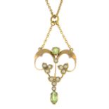 An early 20th century 9ct gold peridot and split pearl openwork pendant, with chain.