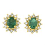 A pair of emerald and diamond cluster earrings.