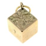 An early 20th century 9ct gold cube charm, with floral motif.