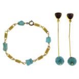 A pair of garnet and turquoise drop earrings and a turquoise fancy-link bracelet.