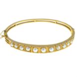 A 9ct gold split pearl hinged bangle.