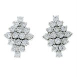 A pair of brilliant-cut diamond cluster earrings.